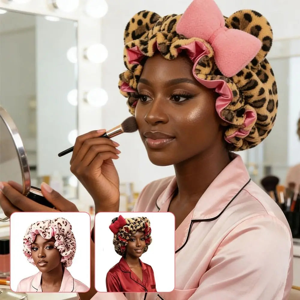 Woman applying makeup while wearing a stylish soft hair drying cap with leopard print and bowknot design.