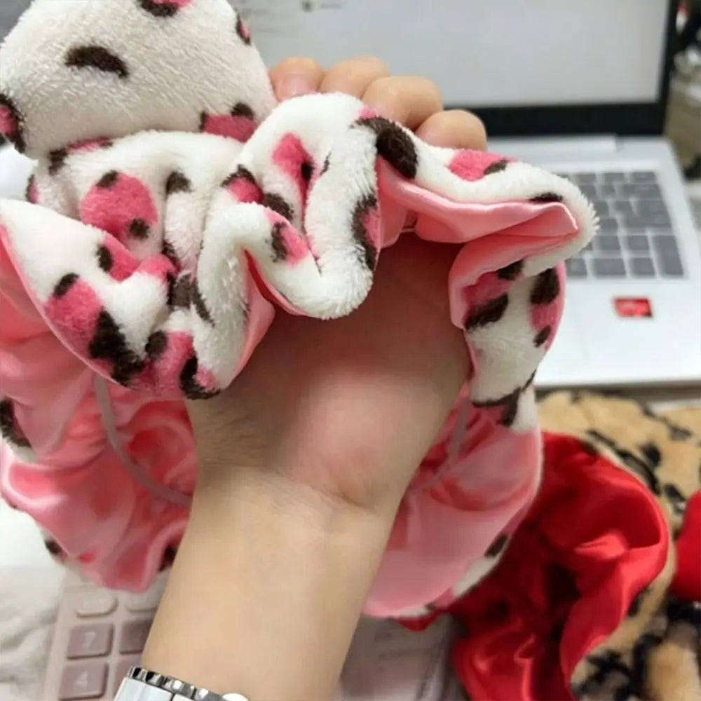 Soft hair drying cap in hand, featuring stylish animal print and soft fabric for quick-drying convenience.